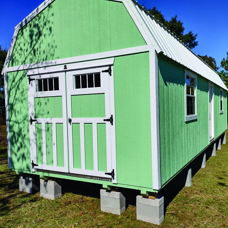 Green Circle E lofted barn with double doors, windows, and a white metal roof