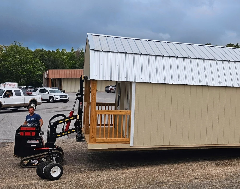 Shed-moving mule positioning a cabin where a full-size truck cannot fit
